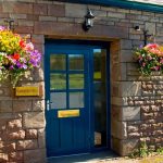 Flowers in hanging baskets at the estate office