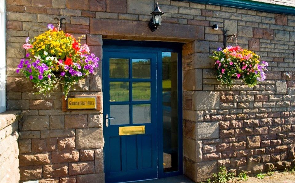 Flowers in hanging baskets at the estate office